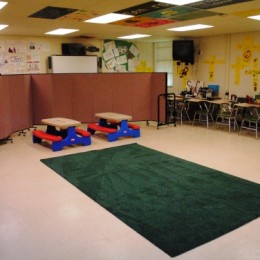 Screenflex Room Divider provides a barrier from classroom material sunday school in a rented classroom.