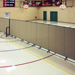 Too hot for outdoor PE class? Screenflex accordion walls are used to divide this gymnatorium. Half is used for PE and half for lunch.