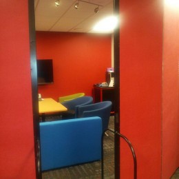 A room divider separates a lounge room from a lecture hall