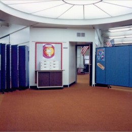 Wall mounted room dividers divide open areas in a school from the classrooms