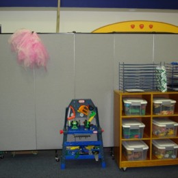 Screenflex Portable Partition Divides a classroom into a play and learning area