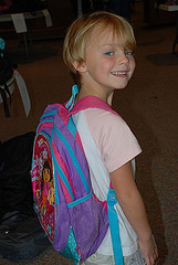 Girl showing of the Dora backpack on her back