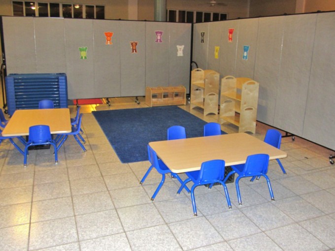 Classroom partition in an L-shape creates a separate daycare room in a church basement