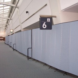 Freestanding partitions extend down an airport terminal to hide access to gate 6