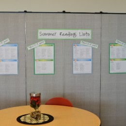 Screenflex Room Divider used in the corner of a room to display summer reading lists