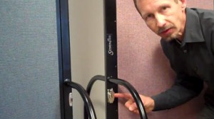 A male shows where a optinal multi-unit connector is located on Screenflex Room Dividers.