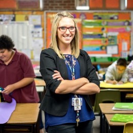Teacher Lauren Edgar poses in her colorful classroom.