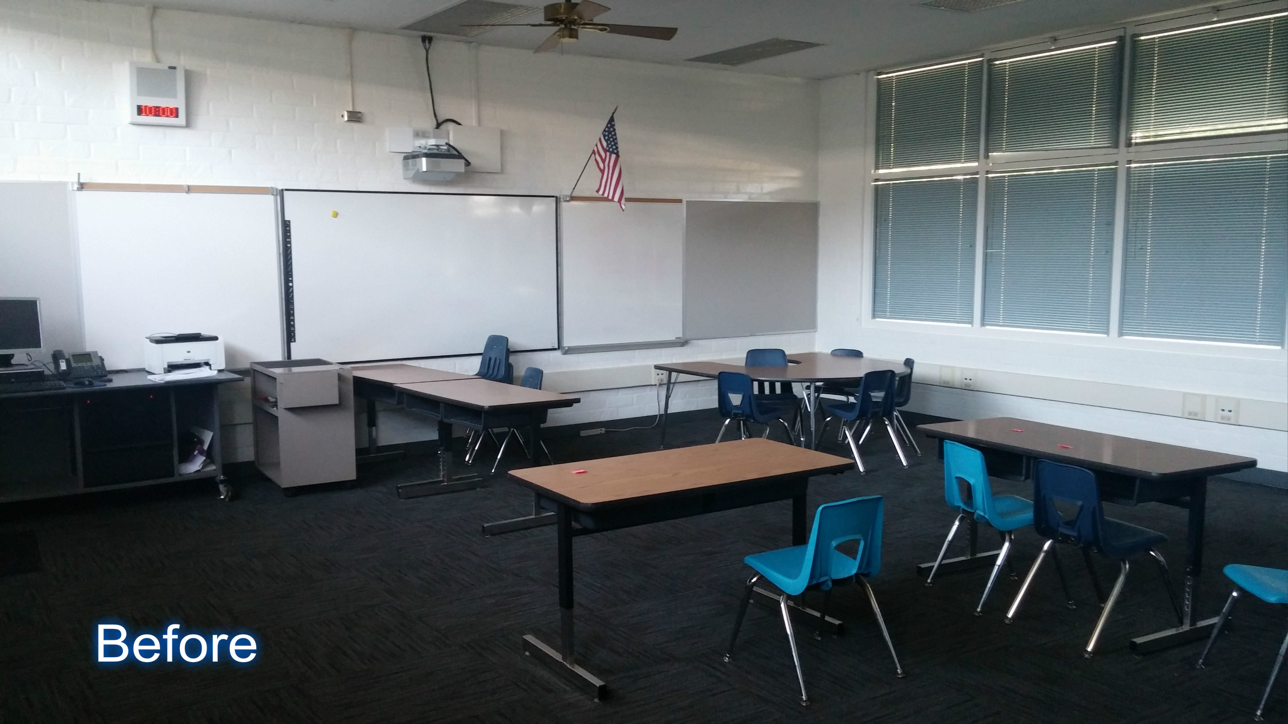 An open classroom with tables and chairs for the teacher and students