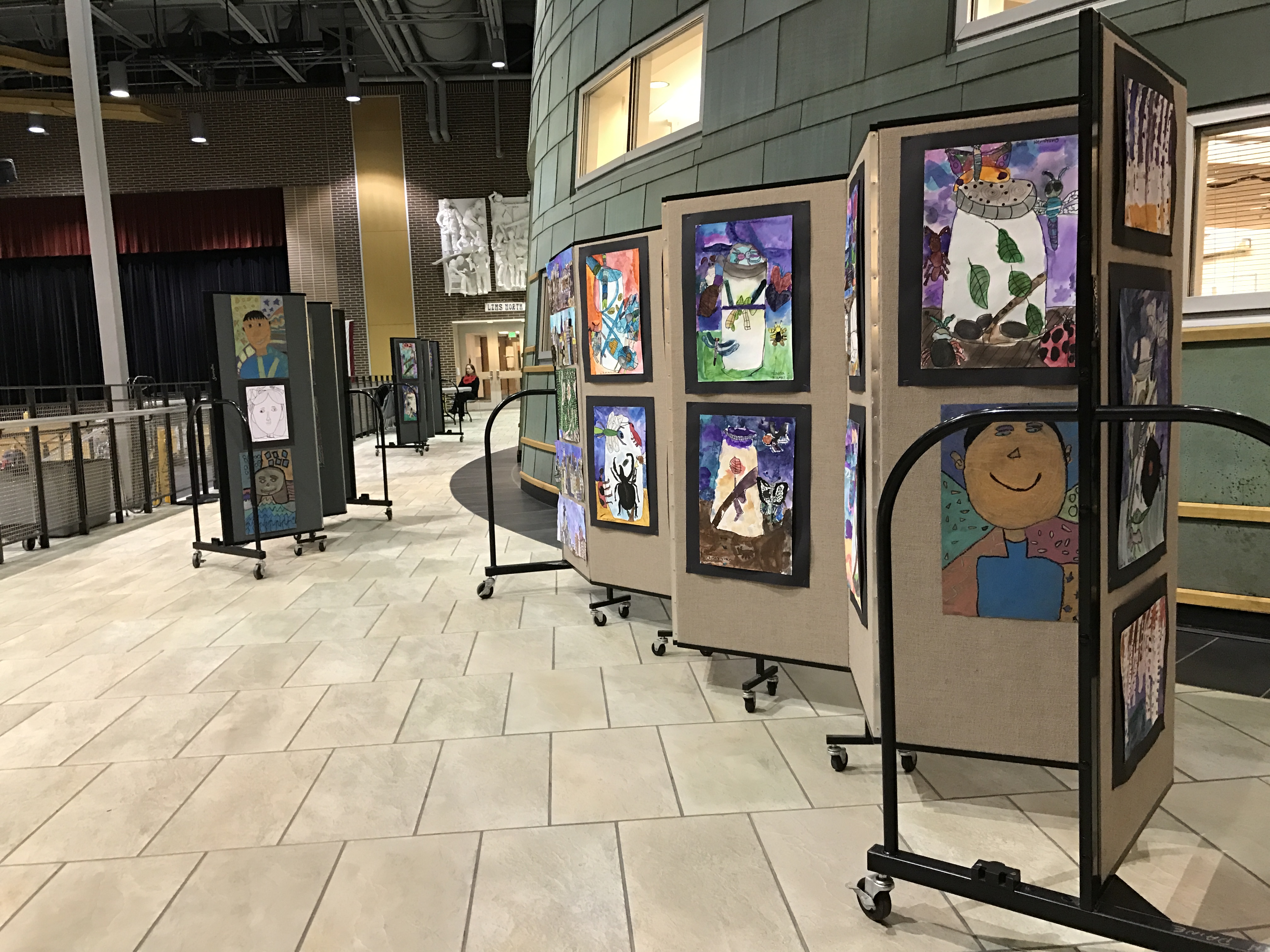 Artwork is displayed on portable partitions in a school