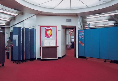 A set of portable room partitions divide a classroom in two